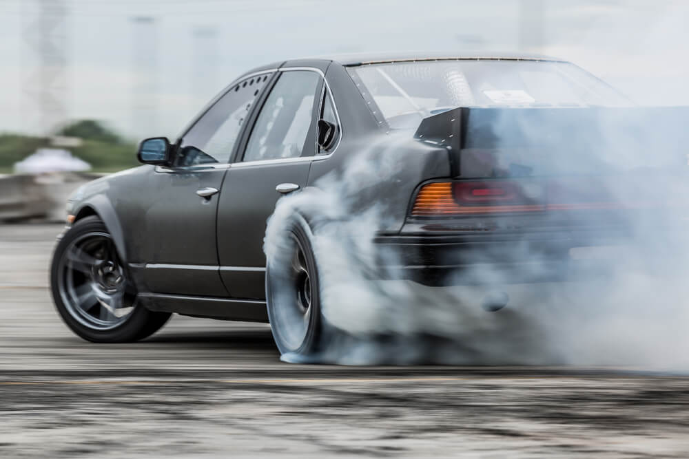 Car drifting, sports car wheel drifting and smoking on track.