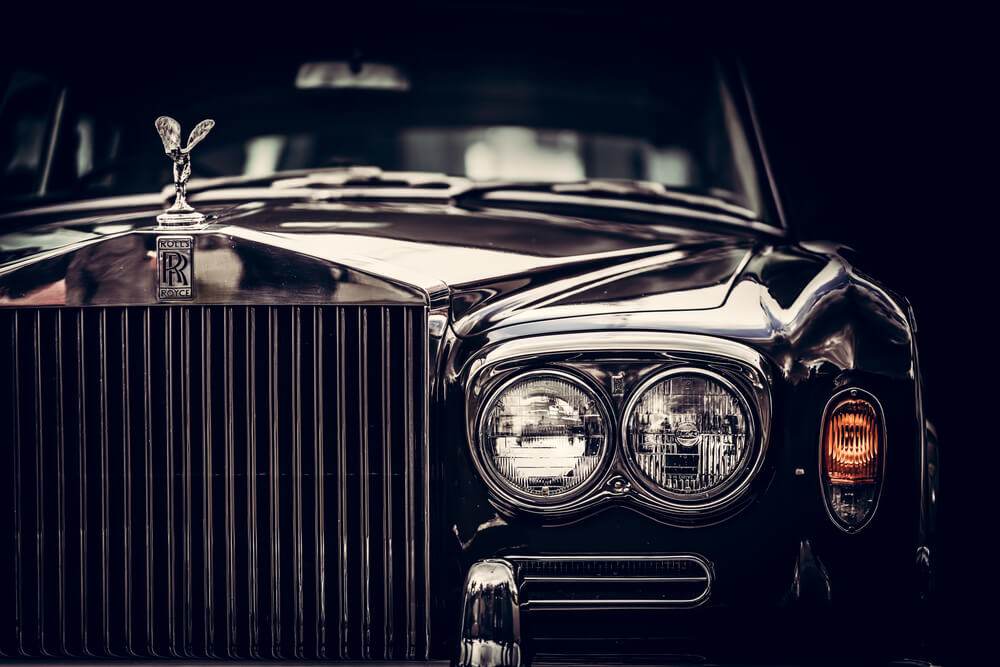 classic British car on black background, close-up. - luxury cars rear-wheel drives