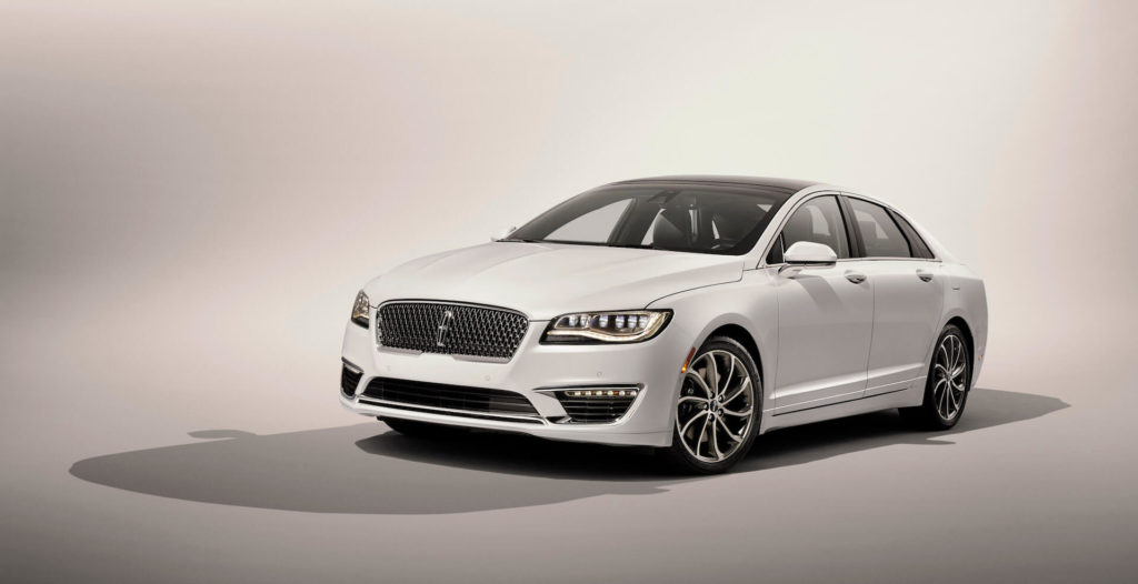 front side view of a white 2020 Lincoln MKZ Hybrid, isolated, grey background.