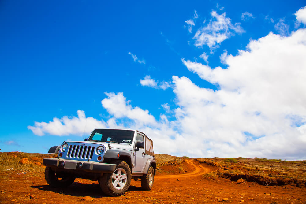 a white Jeep Wrangler in a deserted area. - trucks and jeeps